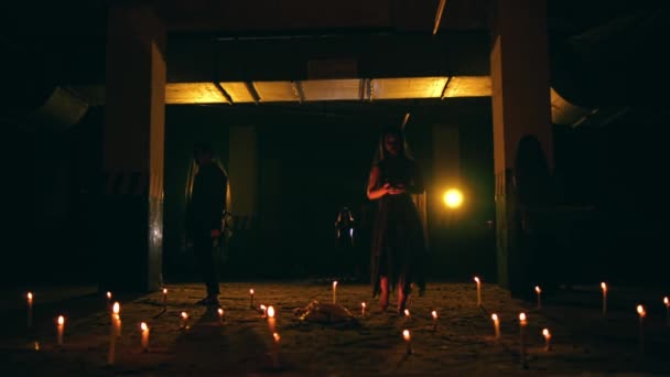 Μια Ομάδα Σατανιστών Μαύρες Ρόμπες Περπατούν Ανάμεσα Κεριά Σχήμα Τριγωνικού — Αρχείο Βίντεο