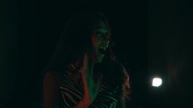 an Asian girl is very enthusiastic and happy when she meets her friends at a night club night