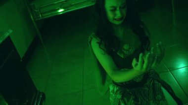 an Asian woman crying and sobbing on the floor when her face was a mess in her room