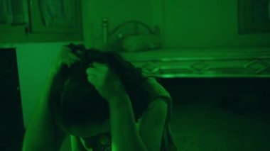 an Asian woman cries because she is bullied and ridiculed by her friends because she is not beautiful when she is alone in her room
