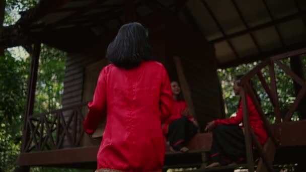 Μια Ομάδα Ταϊλανδών Γυναικών Κόκκινα Φορέματα Που Κάθονται Στις Ξύλινες — Αρχείο Βίντεο