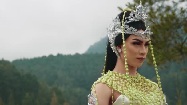 緑の木々に覆われた森の真ん中にある火山噴火口の周りに立つ王の王女 — ストック動画