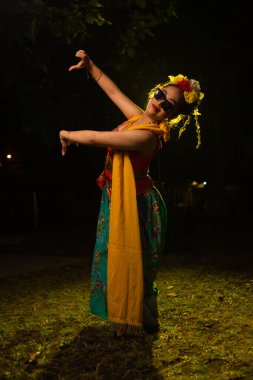 Geleneksel Endonezyalı dansçı geceleri sahnede kıvrılarak dans ediyor.