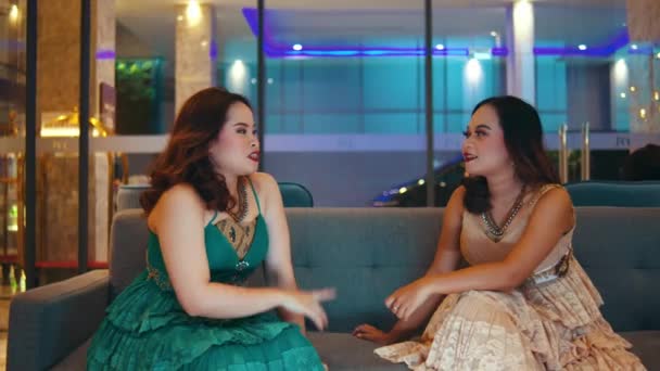 Twee Aziatische Vrouwen Roddelen Een Hotel Stoel Met Levendige Gezichten — Stockvideo