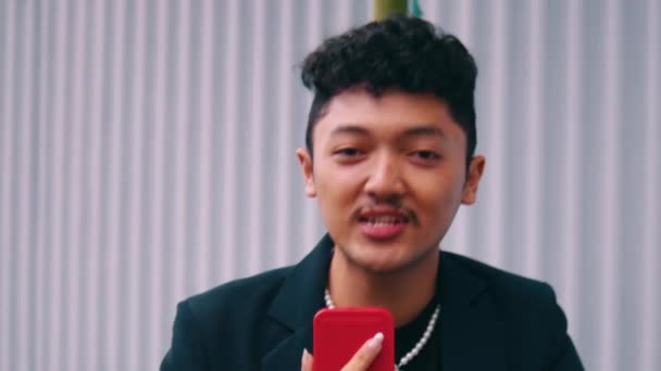 Ein Asiatischer Mann Mit Lockigem Haar Und Schwarzem Anzug Sprach — Stockvideo