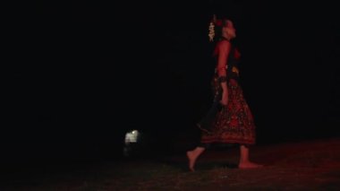 Bir dansçı boş bir tarlada koşar, ağlar ve gece kıpkırmızı parlar.