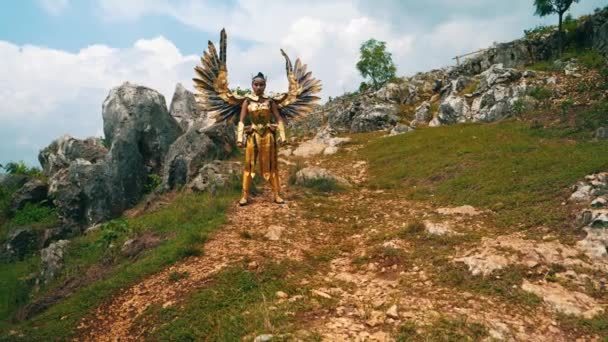 Warlord Golden Wing Costume Stands Boldly Decisively Cliff White Clouds — Stock Video