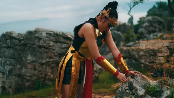 Seorang Ksatria Wanita Sedang Beristirahat Dan Bersandar Pada Batu Besar — Stok Video