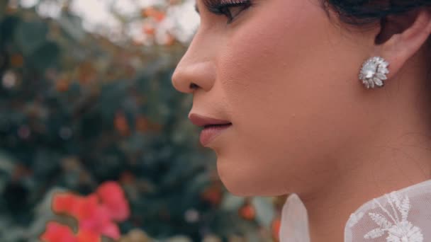 Elegant Woman Diamond Earring Smelling Red Flower Soft Focus Background — Stock Video