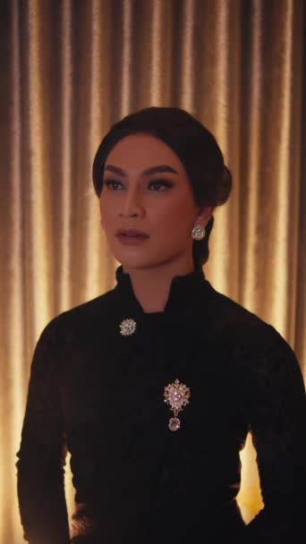 Elegant Woman Black Dress Vintage Earrings Posing Golden Curtain Backdrop — Stock Video