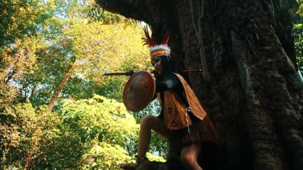 Traditional Woman Tribe Playing Large Tree Lush Forest Setting — Stock Video