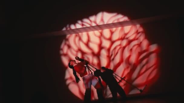 夜间以戏剧性的红灯在舞台上表演的人的轮廓 — 图库视频影像