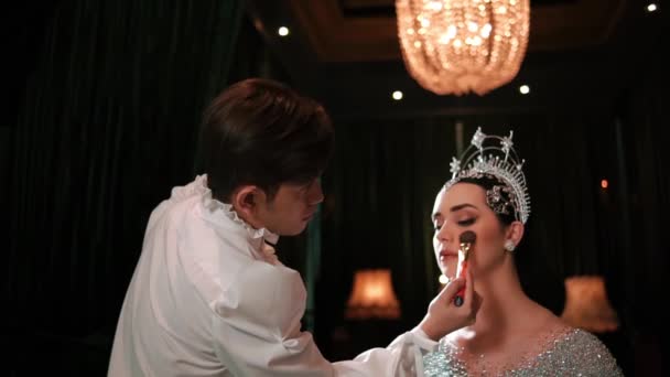 化妆师给一个头戴皇冠 穿着雅致服装的女人涂化妆品 为晚上的活动做准备 — 图库视频影像