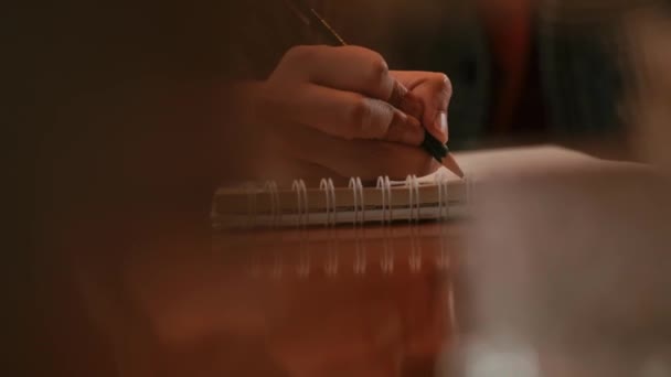 Close Person Hand Writing Notebook Wooden Table Blurred Foreground Morning — Stock Video