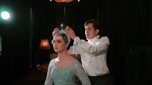 Elegant Woman Sparkling Gown Crown Being Adjusted Man Dark Stage — Stock Video