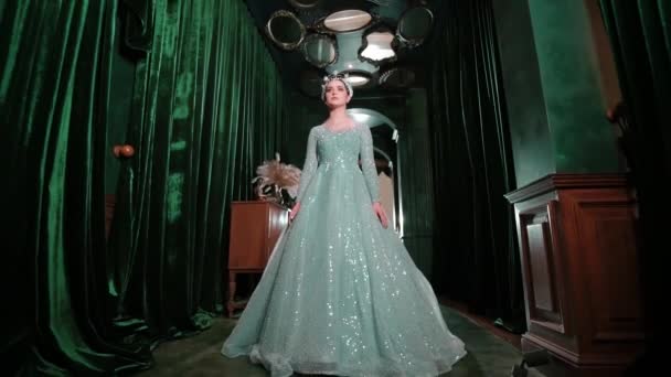 Elegant Woman Sparkling Gown Standing Stage Dramatic Lighting Green Curtains — Stock Video