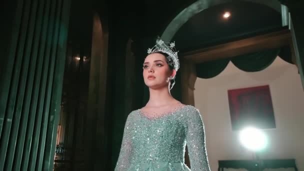 Elegant Woman Sparkling Gown Tiara Posing Grand Hallway Dramatic Lighting — Stock Video