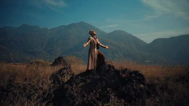 Pria Berpakaian Elegan Berdiri Medan Berbatu Dengan Pegunungan Latar Belakang — Stok Video