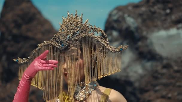 Surreal Portrait Person Artistic Headdress Pink Gloves Posing Rocky Background — Stock Video