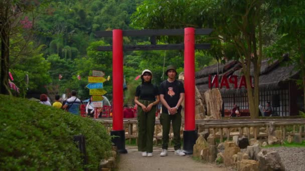 Tourist Couple Posing Traditional Red Torii Gate Historic Site Lush — Stock Video