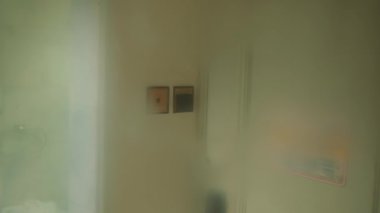 Elektrik prizli bulanık iç duvar ve otelin içinde soluk gölgeler.