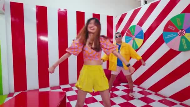 Blurred Motion Two People Dancing Vibrant Colorful Room Checkered Floor — Stock Video