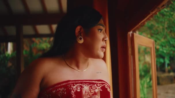 Kırmızı Elbiseli Sakin Bir Kadın Verandada Dikiliyor Düşünceli Bir Ifadeyle — Stok video