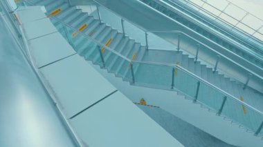 Pürüzsüz tasarımı olan modern bir merdiven, cam parmaklıklar ve minimalist estetik. Merdivenler iyi aydınlatılmış ve üzerinde güvenlik işaretleri var. Temiz ve davetkar bir atmosfer yaratıyor..