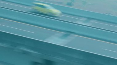 Siyah bir SUV 'un otoyolda sürüşünün bulanık görüntüsü, hareket ve hız gösteriyor. Arka planda bir beton bariyer ve banliyö bölgesini gösteren yeşil bir manzara var..