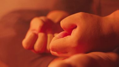 Tahta bir masada oturan ve yanında bir sandalye olan bir kişinin dramatik bir sahnesi. Atmosfer dumanla ve loş ışıkla güçlenir ve tiyatral bir etki yaratır.. 