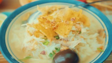 Kavrulmuş cips, doğranmış lahana ve yeşil soğanla süslenmiş bir yüzyıllık karanlık bir yumurta içeren geleneksel Asya erişte çorbası..