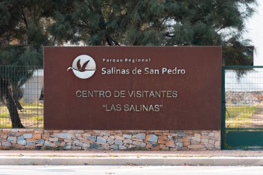  Entrance sign from the street at Salinas de San Pedro centro de visitants or visitor center of las Salinas with a logo of flying flamingo