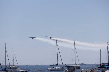 San Javier hava gösterisinde arkalarında dumanlar bırakan iki uçak su üzerinde gösteri yapıyor..