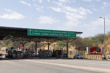 Jaipur Geliştirme Kurumu tarafından yönetilen, birden fazla şerit ve aracın geçtiği, Rajasthan otoyolu üzerindeki gişe plakası..