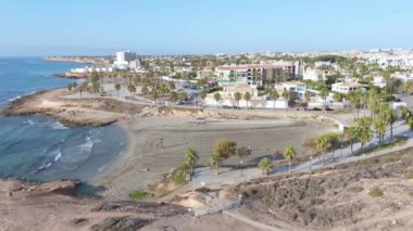 Bu dinamik insansız hava aracı görüntüleri Playa Flamenca 'daki manzaralı Cala Mosca' da sahili, kumlu plajları ve Orihuela Sahili boyunca canlı şehir ortamını yakalar..