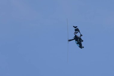 A black autogyro executing a daring stunt maneuver in the sky during the San Javier Airshow in Murcia, Spain, showcasing its agility and unique capabilities clipart