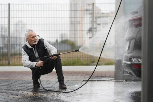 Starší Muž Myje Auto Čisticí Pěnou Proudem Vody Vysokého Tlaku — Stock fotografie