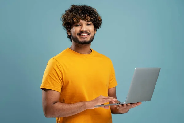 Smiling Indian Man Holding Laptop Computer Working Online Looking Camera — Stok fotoğraf