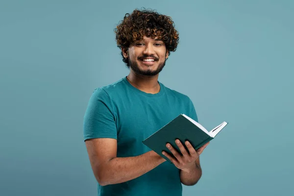 Portrait Handsome Smiling Indian Man Reading Book Isolated Blue Background — Stock Photo, Image