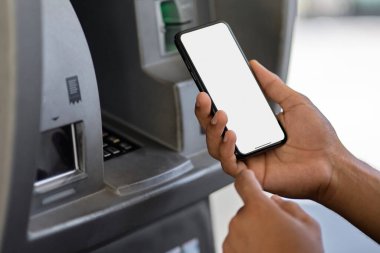 Man hand using mobile phone at gas pump station to pay for gasoline. Automotive industry or transportation and ownership concept. Delivery service concept. Isolated 