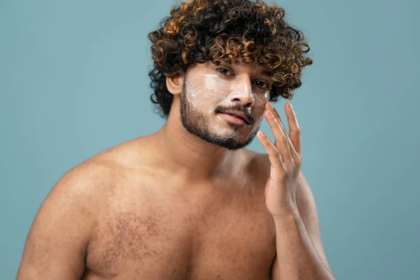 Handsome Curly Haired Young Shirtless Indian Man Applying Moisturizer His — Stok fotoğraf