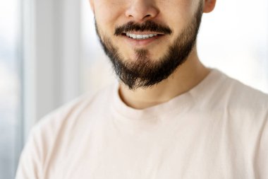Closeup portrait of handsome smiling bearded man after barbershop