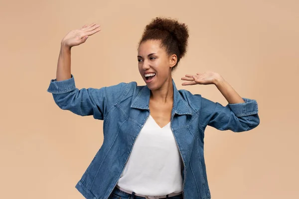Happy Woman Afro Hairstyle Raised Arms Dancing Celebrating Indoor Studio — Stockfoto
