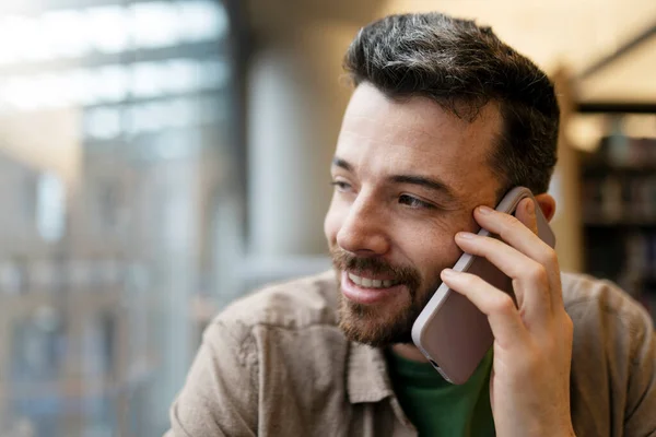 Hezký Usměvavý Latinskoamerický Obchodník Který Mluví Mobilním Telefonu Sedí Moderní — Stock fotografie