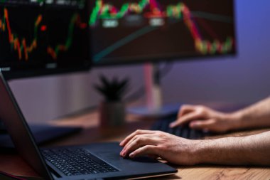 Closeup of crypto trader hands using laptop, typing on keyboard, working online with crypto chart sitting in modern office, researching and analyzing market. Successful business, online trading clipart