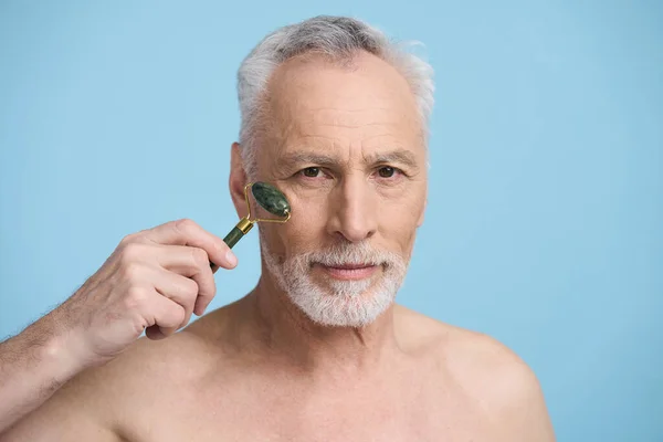 Closeup Caucasian Senior Man Massaging Face Special Stone Roller Massager — Stock Photo, Image