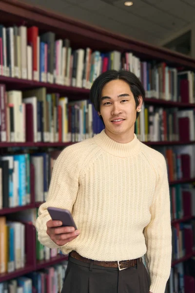 Vista Vertical Estudante Universitário Japonês Inteligente Segurando Telefone Celular Biblioteca — Fotografia de Stock
