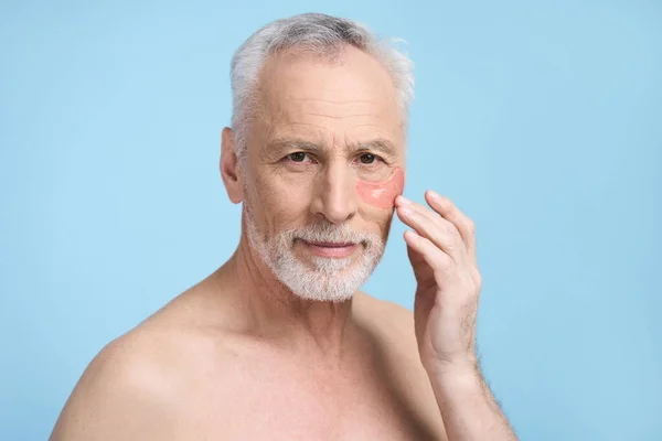 Handsome Caucasian Senior Man Applying Hydrogel Patches Smoothing Puffiness Removing — Stock Photo, Image