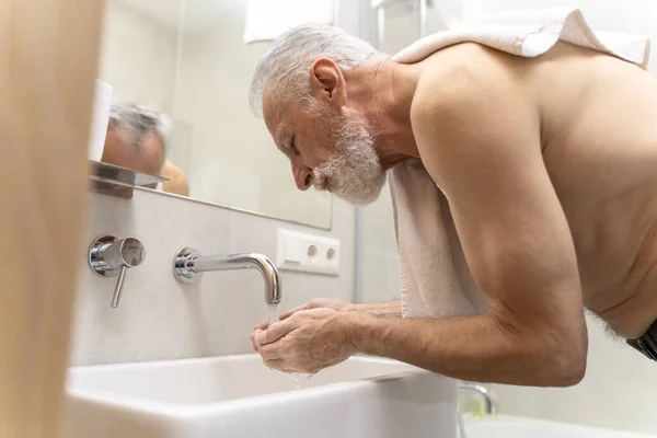 Attractive Senior Man Washing Face Standing Bathroom Holding Towel Mature — Stock Photo, Image
