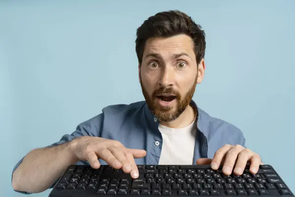 Emotional Bearded Man Casual Denim Typing Keyboard Isolated Blue Background — Stock Photo, Image